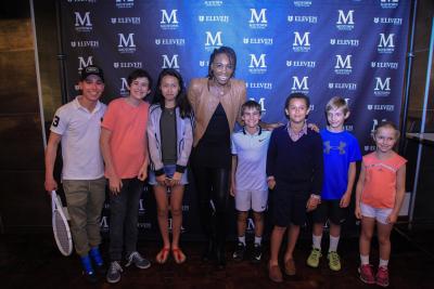 Venus Williams poses for a photo with some young tennis players at Midtown Sanctuaire.